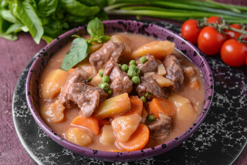  Bowl with tasty beef stew on table