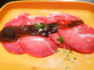 Wall Mural - Close up of Rare Slices beef for japanese yakiniku barbecue or Korean barbecue grilling