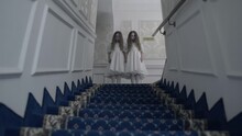 Terrible Ghost Twins Looking Down Stairs Standing In Spooky Hotel Corridor, Fear