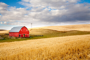a red barn in the fall season in the palouse wheat country in southeastern washington.