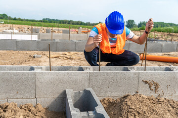 the construction worker builds the foundation of the building