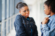 © AS Photo Family - Two african woman friends with sad faces in jeans jacket posed indoor together.