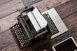 © Gabriel Trujillo/ADDICTIVE STOCK - From above of retro typewriter placed on table with modern netbook and tablet