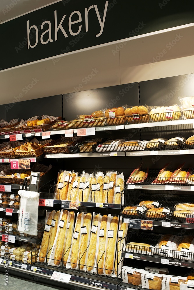 supermarket bakery display showing loaf, bread rolls, Stock Photo ...