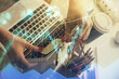 © peshkova - Double exposure of businesswoman hands typing on computer and financial graph hologram drawing. Stock market analysis concept.