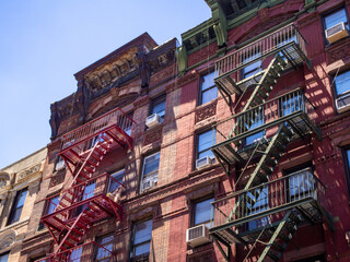 Poster - classic New York City red brick facade with fire escapes in Chinatown