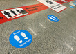 © rarrarorro - Stickers on the floor near the baggage claim belt at the airport that warn of keeping social distance during the health emergency during the coronavirus pandemic