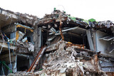 Fototapeta Niebo - a concrete building being demolished