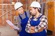 © JackF - Workers man and woman discuss construction plan. High quality photo