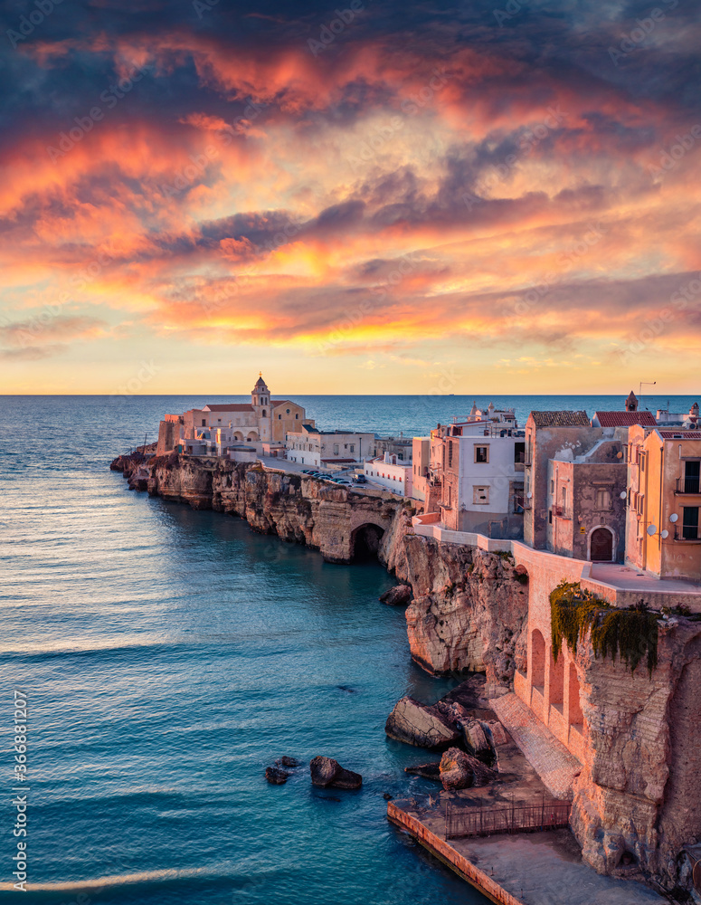 Stunning morning cityscape of Vieste - coastal town in Gargano National Park, Italy, Europe. Colorful summer sunrise on Adriatic sea. Traveling concept background. - obrazy, fototapety, plakaty 