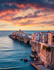 Stunning morning cityscape of Vieste - coastal town in Gargano National Park, Italy, Europe. Colorful summer sunrise on Adriatic sea. Traveling concept background.