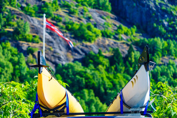 Wall Mural - Car with canoe on top roof in mountains