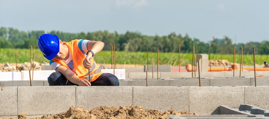 the construction worker builds the foundation of the building