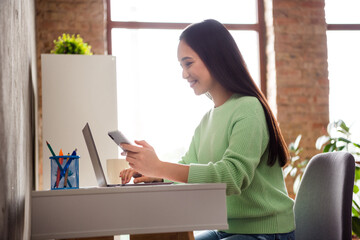 Poster - Profile side photo of positive korean blogger girl sit comfort table work remote use cellphone blogging social media post comment in house indoors