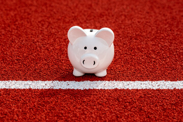 Wall Mural - Piggy bank on starting line in the stadium