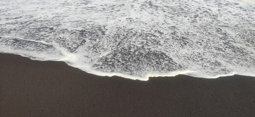 Soft wave of the Pacific Ocean on a sandy beach.