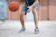 © Vladimir - Man plays basketball in the street yard during the day