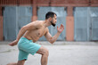 © Vladimir - Athlete runs fast in the street yard