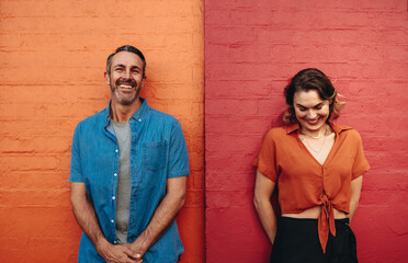 Couple standing by multicolored wall