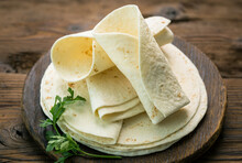 Whole Wheat Flour Tortilla On The Wooden Table Background 
