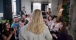 © vadim_key - Rear view blonde female boss business woman motivating multiethnic employees, team clap at office seminar slow motion.
