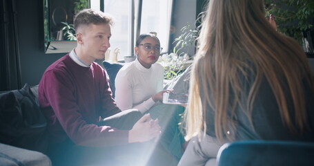 Sticker - Lens flare shot, modern light workplace atmosphere. Multiethnic young business people discuss work at trendy loft office