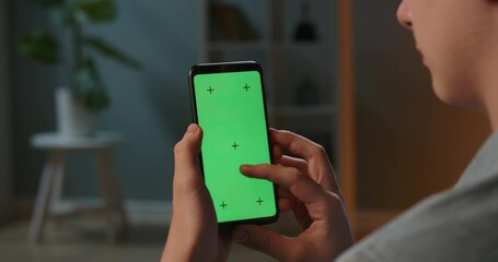 close up shot of guy using his smart phone with mock up green screen at night, using various gesture