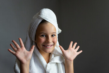 adorable little girl happy smiling after spa bath on a white bath towel head