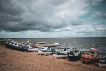 Wall Mural - At Beach of Jaroslawiec in Poland fishing boats lie on the beach of the Baltic Sea