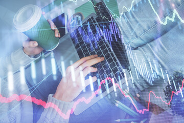 Double exposure of woman hands typing on computer and forex chart hologram drawing. Stock market invest concept.