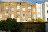 Fototapeta  - A variety of window decorate brick building facades in London 