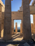 Fototapeta  - Archaic columns still standing among ruins 