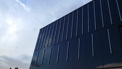 black facade of the building against the blue sky