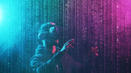 Portrait of a man in virtual reality helmet over abstract digital background. Obscured dark face in VR goggles. Internet, darknet, gaming and cyber simulation.