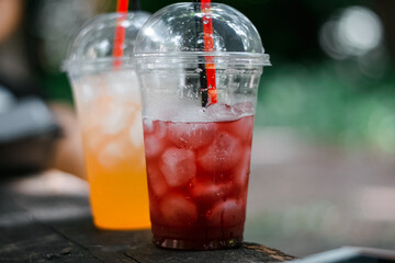 two glasses with orange and strawberry juice