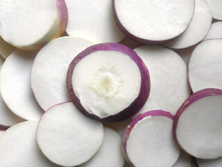 Wall Mural - White and purple color sliced cut ripe Turnip root