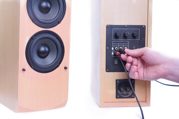 hand holds a wire connecting two columns on a white background