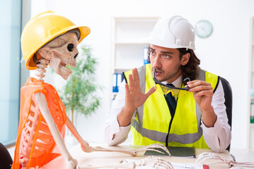 Funny construction business meeting with boss and skeletons