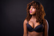 © Ranta Images - Young beautiful African woman against black background
