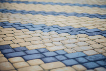 Nested pavers of various colors, around the grass is green, chic garden