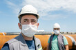 © Funtay - The workers are using protective masks for pandemic of the coronavirus (covid-19) in the construction site.