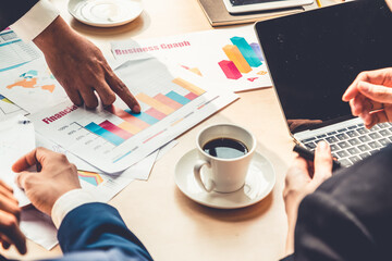 Wall Mural - Smart businessman and businesswoman talking discussion in group meeting at office table in a modern office interior. Business collaboration strategic planning and brainstorming of coworkers.