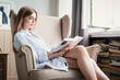 Woman reading a novel relax at home. Quarantine Indoor lifestyle. Leisure indoors entertainment.