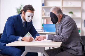 Two businessmen wearing masks during negotiations