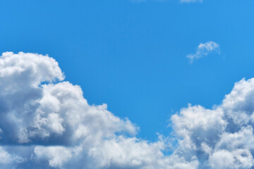 White clouds in blue summer sky with copy space