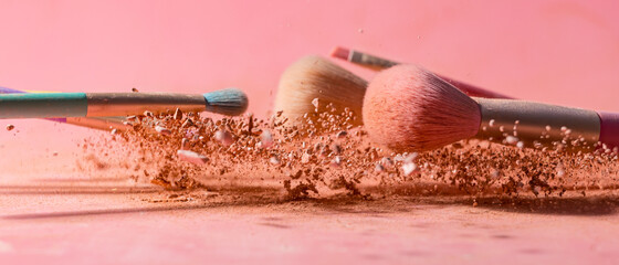 Canvas Print - Make up brushes with powder splashes isolated on pink background