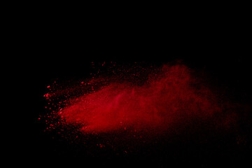 Wall Mural - Red colored sand splash against black background. 