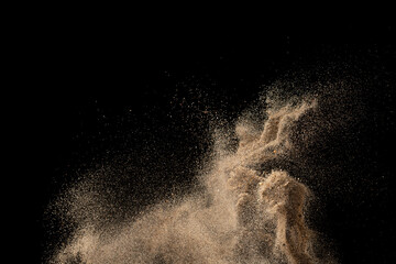 Wall Mural - Gold sand explosion isolated on black background. Abstract sand cloud.