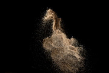 Wall Mural - Gold sand explosion isolated on black background. Abstract sand cloud.