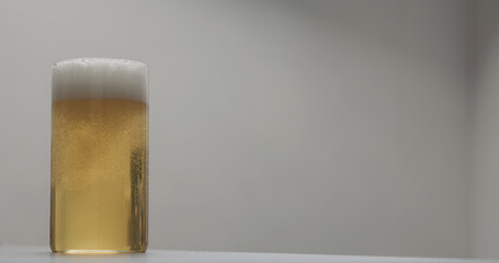 pour apple cider into glass on terrazzo countertop with copy space